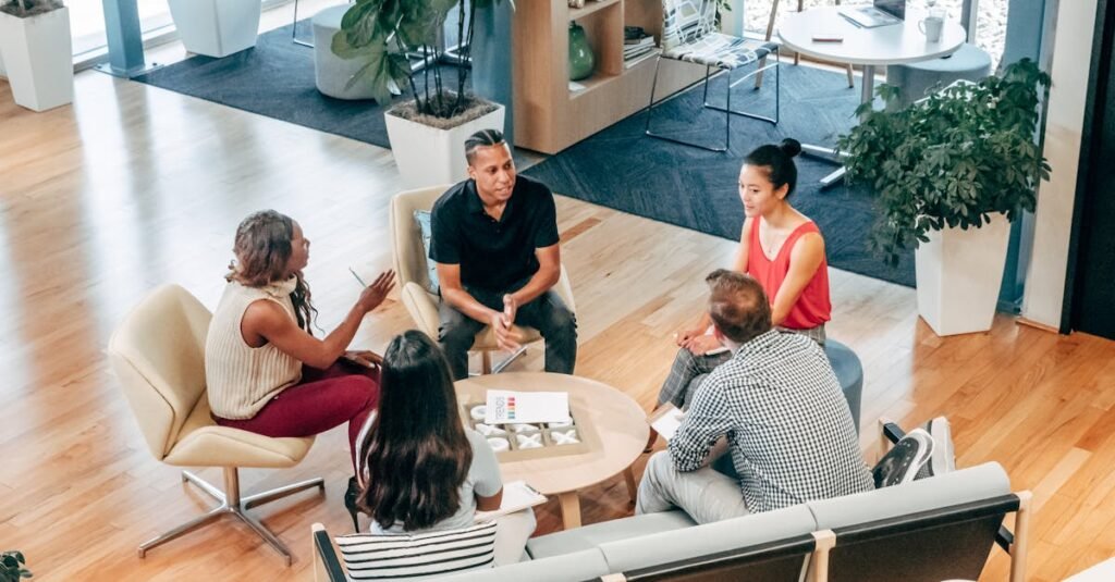 A diverse group of professionals engage in a collaborative team meeting in a stylish office environment.